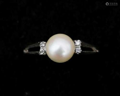 An 18 karat white gold ring, set with a cultured pearl and d...