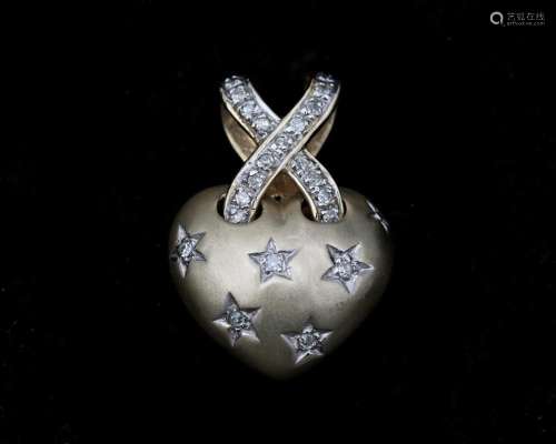 A 14 karat gold heart-shaped pendant set with diamonds.