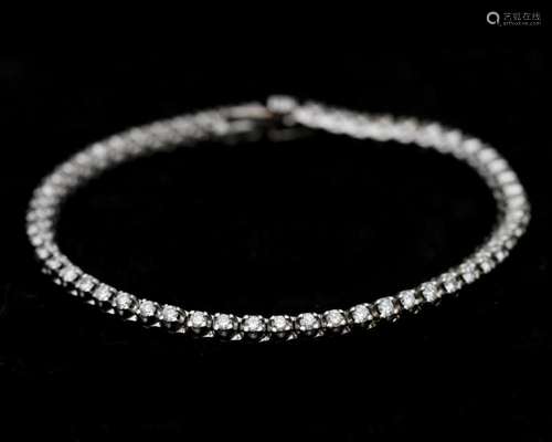 A 18 karat white gold tennis bracelet, set with 1.92ct. diam...