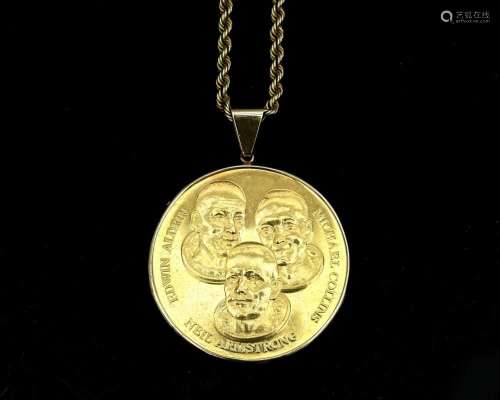 A 14 karat gold cord linked necklace, with a commemorative m...