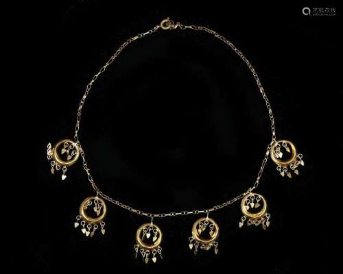A 14 karat golden fantasy linked necklace with five open cir...