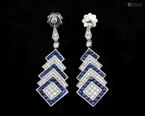 A pair of 14 karat white gold earrings, with diamonds and sa...