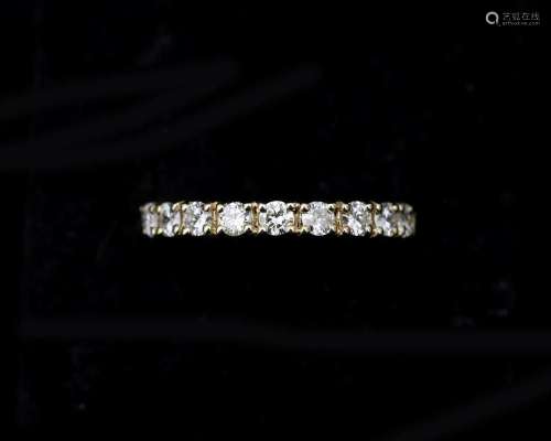 A 14 karat gold Alliance ring, set all around with diamonds ...