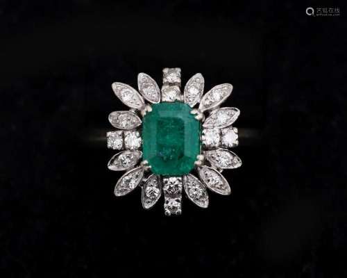 A 14 karat gold entourage ring set with diamonds and emerald