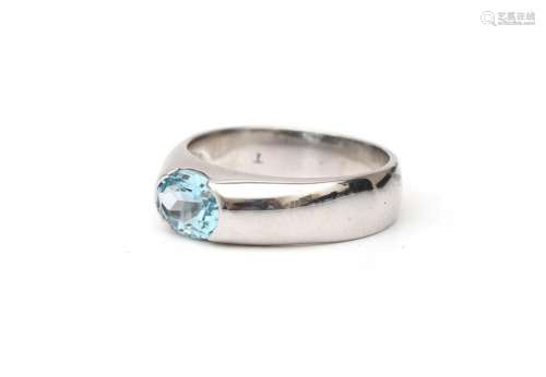 A 18 karat white gold solitaire ring, set with a blue Topaz