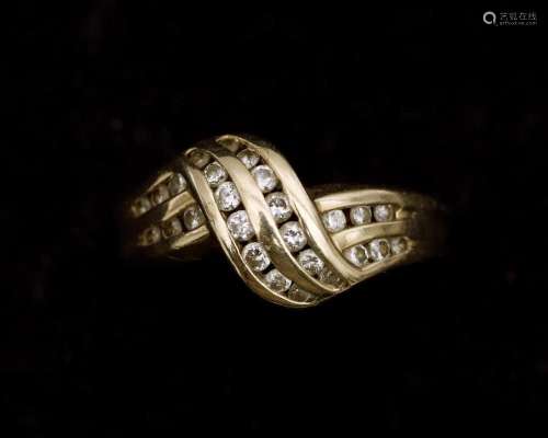 A 14 karat gold ring set with a brilliant cut diamonds.