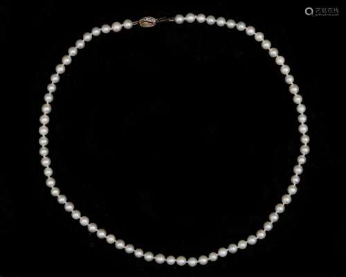 A Akoya pearl necklace with 14 karat. tri-color gold clasp.