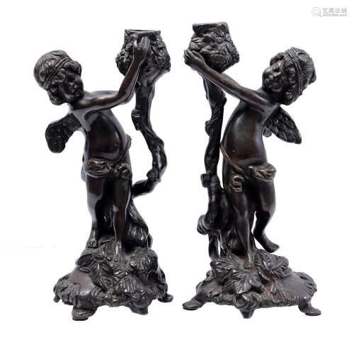 1 pair of bronze putti candlesticks