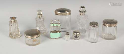 A group of cut glass dressing table bottles and jars with si...