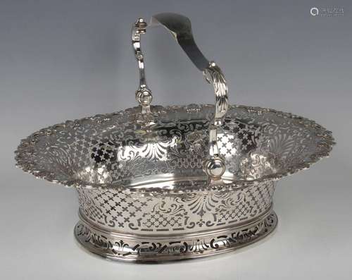 A George II silver oval cake basket with foliate capped scro...