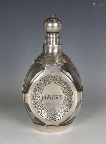 A Haig's whisky silver mounted clear glass dimple decanter a...