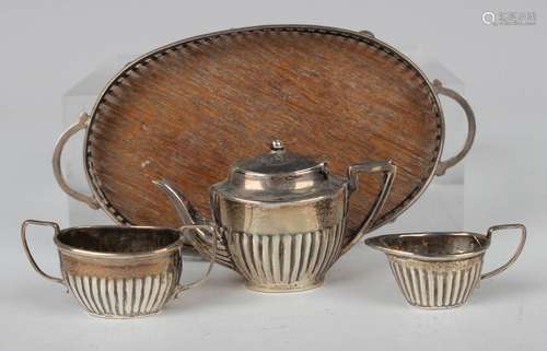 An Edwardian silver toy four-piece tea set of oval half-reed...