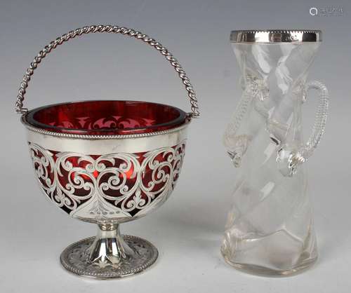 A Victorian silver bonbon basket with spiral swing handle, t...