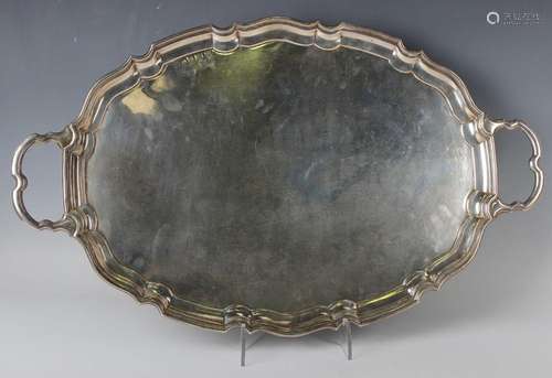 A George V silver oval two-handled tea tray with raised shap...