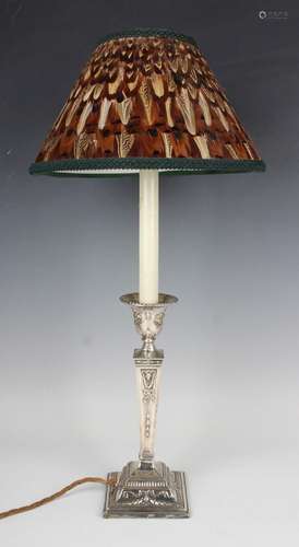 An Edwardian silver candlestick, the urn shaped sconce with ...