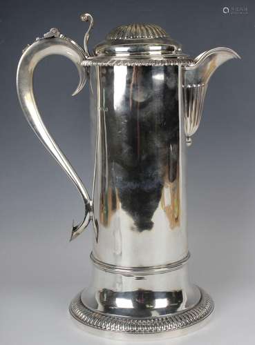 A George IV large silver flagon with reeded domed hinged lid...