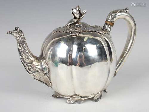 A William IV silver melon teapot, the leaf shaped hinged lid...