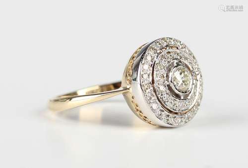 A gold and diamond circular cluster ring, claw set with the ...