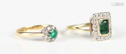 A gold, platinum, emerald and diamond circular cluster ring,...