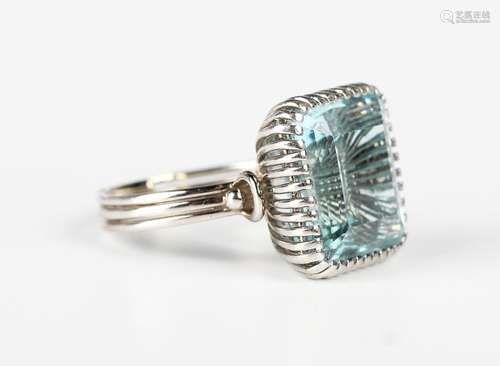 A white gold and aquamarine single stone ring, claw set with...