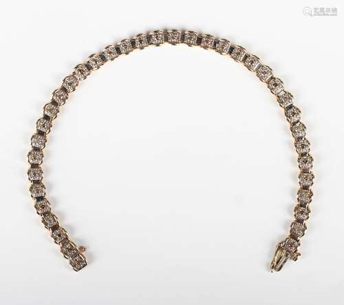 A 9ct gold and diamond bracelet, mounted with a row of circu...