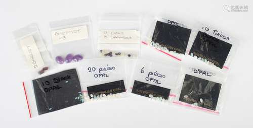 A collection of unmounted gemstones, including three cabocho...