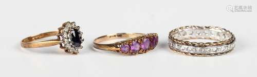 A 9ct gold and amethyst five stone ring, mounted with a row ...