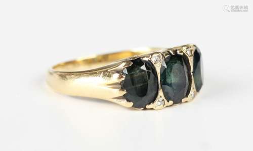 A gold ring, mounted with three oval cut bluish green sapphi...