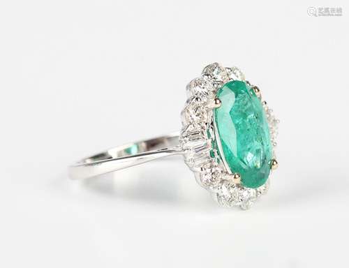 A white gold, treated emerald and diamond cluster ring, claw...