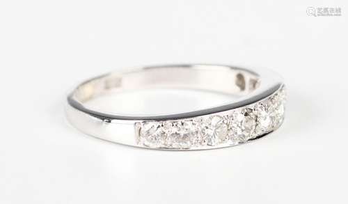 A white gold and diamond nine stone half-hoop eternity ring,...