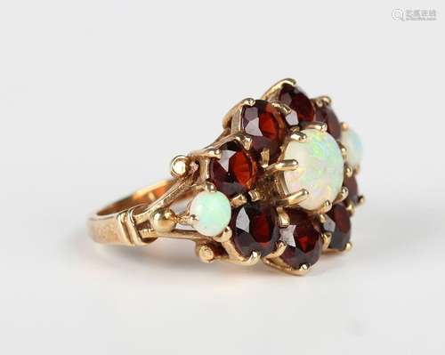 A 9ct gold, opal and garnet large cluster ring, claw set wit...