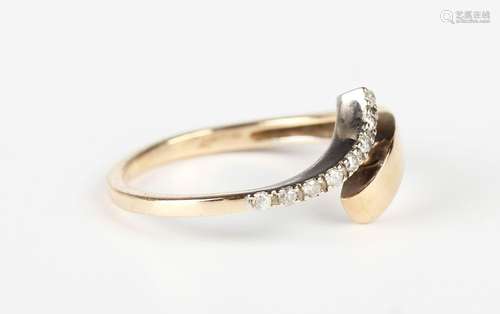 A 9ct two colour gold and diamond ring in an abstract twisto...