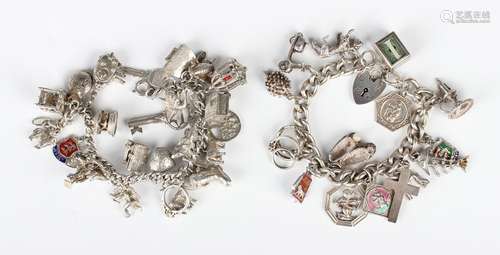 Two silver charm bracelets, each fitted with a variety of mo...