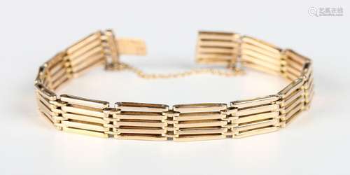 A gold bar and oval link gate bracelet on a snap clasp, deta...