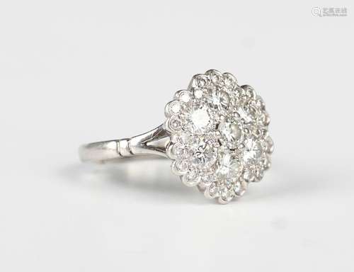 A platinum and diamond cluster ring, mounted with seven prin...