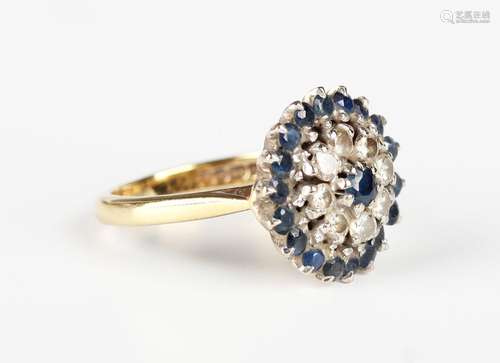 An 18ct gold, sapphire and diamond cluster ring, claw set wi...