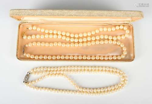 A two row necklace of uniform cultured pearls on a base meta...