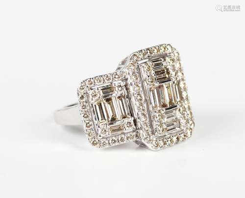 A 9ct white gold and diamond ring in a large triple panel sh...