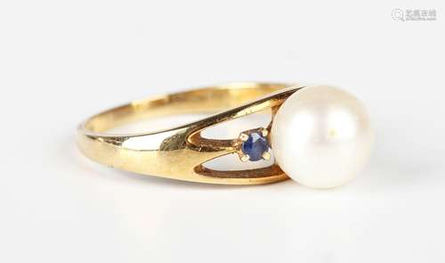 A gold ring, mounted with a cultured pearl between two circu...