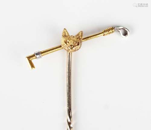 A gold stickpin, the finial designed as a fox's mask and a r...