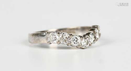 An 18ct white gold and diamond seven stone ring in a wishbon...