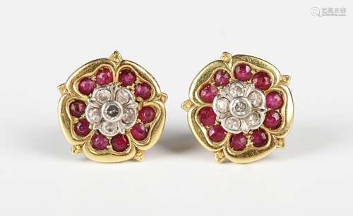 A pair of gold, diamond and ruby earstuds, each designed as ...