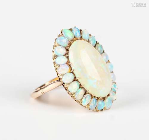 A gold and opal cluster ring, claw set with the principal ov...