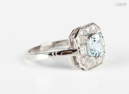 A platinum, aquamarine and diamond square cluster ring, claw...