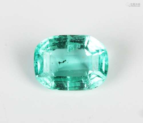 An unmounted step cut emerald, dimensions approx 0.90mm x 5....