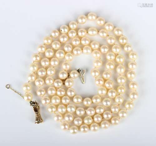 A single row necklace of uniform cultured pearls on a 9ct go...