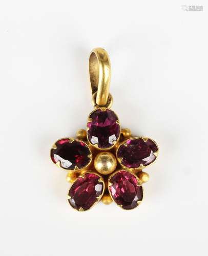 A gold and garnet pendant, claw set with five oval cut garne...