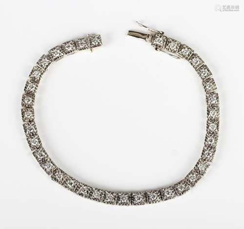 A white gold and diamond bracelet, mounted with a row of cir...