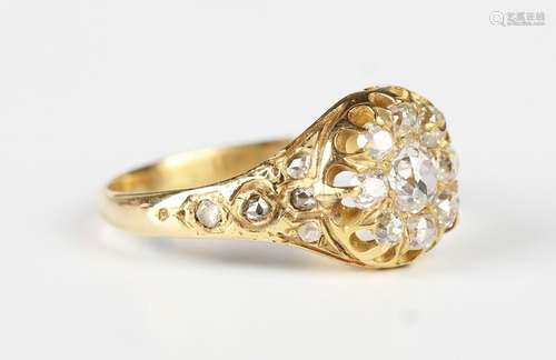 A gold and diamond cluster ring, mounted with the principal ...