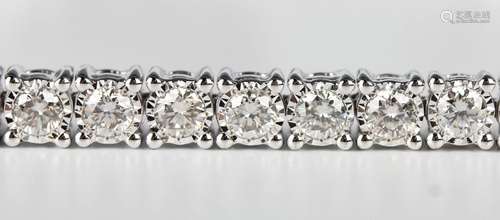 A 9ct white gold and diamond line bracelet, mounted with a r...